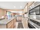 Open kitchen with island, stainless steel appliances and granite countertops at 11050 E Ravenna Ave, Mesa, AZ 85212