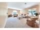 Spacious living room with carpeted floors and neutral decor at 11050 E Ravenna Ave, Mesa, AZ 85212