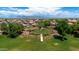 Scenic neighborhood park with a circular pathway and lush landscaping at 11050 E Ravenna Ave, Mesa, AZ 85212