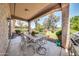 Covered patio with seating area, overlooking a grassy backyard at 11050 E Ravenna Ave, Mesa, AZ 85212