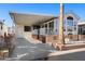 Inviting exterior of manufactured home with covered patio and landscaping at 111 S Greenfield Rd # 488, Mesa, AZ 85206