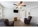 Bright living room featuring hardwood floors, comfy chairs, and a ceiling fan at 111 S Greenfield Rd # 488, Mesa, AZ 85206