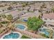 Aerial view of property featuring backyard pool, spa, palm trees, and desert landscaping at 1383 E Prescott Pl, Chandler, AZ 85249