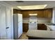 Efficient kitchen with breakfast bar, plentiful cabinets and white appliances at 1550 N Stapley Dr # 35, Mesa, AZ 85203