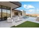 Outdoor living space features an in-ground pool, fire pit, and lounge area at 15609 E Palatial Estates Dr, Fountain Hills, AZ 85268