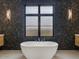 Bathroom with freestanding tub and dark hexagon tile at 15609 E Palatial Estates Dr, Fountain Hills, AZ 85268