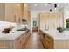 Modern kitchen featuring a kitchen island, light wood cabinetry, white countertops, and stainless steel appliances at 15609 E Palatial Estates Dr, Fountain Hills, AZ 85268