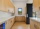 Bright laundry room with wood cabinets and quartz countertops at 15609 E Palatial Estates Dr, Fountain Hills, AZ 85268