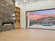 Bright living room with fireplace and large windows showcasing scenic views at 15609 E Palatial Estates Dr, Fountain Hills, AZ 85268