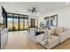 A cozy living room featuring modern furniture, a ceiling fan, and large windows with scenic outdoor views at 15609 E Palatial Estates Dr, Fountain Hills, AZ 85268