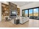 Bright living room with fireplace, built-in shelves, and a large sliding door that leads to an outdoor patio at 15609 E Palatial Estates Dr, Fountain Hills, AZ 85268