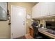 Convenient laundry room with cabinets and workspace at 15666 W Arbor Trl, Surprise, AZ 85374