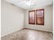 Bright bedroom with tile flooring, ceiling fan, and plantation shutters at 16115 W Vale Dr, Goodyear, AZ 85395