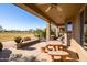 Relaxing patio with seating area and golf course view at 16115 W Vale Dr, Goodyear, AZ 85395