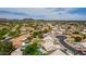 A community view with a backdrop of mountain views, lush green spaces, and manicured homes with tile roofs at 18014 N 63Rd Ln, Glendale, AZ 85308