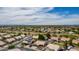Panoramic aerial photo highlighting a community with solar panels, mature trees and beautiful landscaping at 18014 N 63Rd Ln, Glendale, AZ 85308