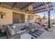 Relaxing back patio with comfortable seating, stylish pergola, and inviting outdoor decor at 18014 N 63Rd Ln, Glendale, AZ 85308