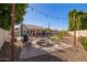 Inviting backyard with a fire pit, outdoor seating, and string lights, perfect for entertaining guests at 18014 N 63Rd Ln, Glendale, AZ 85308