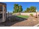 Spacious backyard featuring a well-maintained lawn, attractive desert landscaping, and inviting pool at 18014 N 63Rd Ln, Glendale, AZ 85308