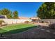 Landscaped backyard features a lush lawn, patio area, and a privacy fence, perfect for outdoor enjoyment at 18014 N 63Rd Ln, Glendale, AZ 85308
