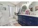 Bathroom boasts walk-in marble shower, double vanity with storage, and decorative mirrors at 18014 N 63Rd Ln, Glendale, AZ 85308