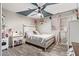 Comfortable bedroom with a geometric ceiling design, complemented by hardwood floors and natural light at 18014 N 63Rd Ln, Glendale, AZ 85308