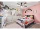 Pink bedroom features a ceiling fan, light colored floors, natural light, and cozy decor at 18014 N 63Rd Ln, Glendale, AZ 85308