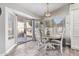 Cozy dining area with backyard views, natural light, and stylish furniture at 18014 N 63Rd Ln, Glendale, AZ 85308