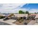 Well-kept single-story home with desert landscaping, two-car garage and solar panels on the neighboring house at 18014 N 63Rd Ln, Glendale, AZ 85308