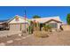 Single-story home boasting a desert landscape, a two-car garage, and an American flag at 18014 N 63Rd Ln, Glendale, AZ 85308
