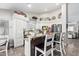 Bright kitchen features stylish wood and granite island, stainless appliances, white cabinets and decor at 18014 N 63Rd Ln, Glendale, AZ 85308