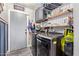 Organized laundry room with modern appliances, ample storage shelves, and stylish design elements at 18014 N 63Rd Ln, Glendale, AZ 85308