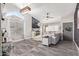 Modern living room with a gray sofa, high ceilings, a feature wall and ample natural light at 18014 N 63Rd Ln, Glendale, AZ 85308