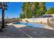 Inviting pool area with a waterfall feature, spacious deck, and lush landscaping for outdoor enjoyment at 18014 N 63Rd Ln, Glendale, AZ 85308