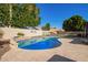 Beautiful pool with custom tile work, basketball hoop, and a spacious patio for relaxation and entertainment at 18014 N 63Rd Ln, Glendale, AZ 85308
