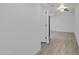 Interior hallway with light gray walls and wood-look flooring at 18202 N Cave Creek Rd # 241, Phoenix, AZ 85032