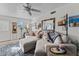 Living room with sectional sofa and large windows at 1875 W Aguila Dr, Wickenburg, AZ 85390