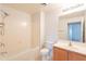 The bathroom is tiled with a shower and wood vanity at 19700 N 76Th St # 2072, Scottsdale, AZ 85255