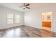 This primary bedroom is spacious with wooden floors and an attached bathroom at 19700 N 76Th St # 2072, Scottsdale, AZ 85255
