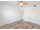This spacious bedroom has light gray floors and a ceiling fan at 19700 N 76Th St # 2072, Scottsdale, AZ 85255