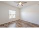 Bright bedroom featuring wood floors, a ceiling fan, and a window overlooking the exterior at 19700 N 76Th St # 2072, Scottsdale, AZ 85255