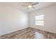 Bright bedroom featuring wood floors, a ceiling fan, and a window for natural light at 19700 N 76Th St # 2072, Scottsdale, AZ 85255