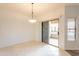 Bright dining room featuring tile floors, a modern chandelier, and sliding glass doors to the patio at 19700 N 76Th St # 2072, Scottsdale, AZ 85255