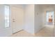 Bright entryway hallway featuring tiled floors, a white front door, and a view into an adjacent room at 19700 N 76Th St # 2072, Scottsdale, AZ 85255