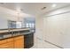 Kitchen view showing stainless steel sink, dishwasher, and pantry/storage, with views into the living area at 19700 N 76Th St # 2072, Scottsdale, AZ 85255