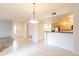 Open living area with decorative lighting fixture next to a modern kitchen with stainless appliances at 19700 N 76Th St # 2072, Scottsdale, AZ 85255