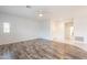 Bright living area with wood-look floors, white walls, and an open layout to the front door at 19700 N 76Th St # 2072, Scottsdale, AZ 85255