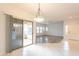 Open layout with hardwood floors transitioning to tile, connecting to a sliding glass door and balcony at 19700 N 76Th St # 2072, Scottsdale, AZ 85255