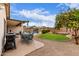 Well-kept backyard with a built-in BBQ, outdoor seating, orange tree and a refreshing pool in the background at 22415 N 34Th Ln, Phoenix, AZ 85027