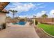 Fenced backyard featuring a sparkling pool, patio space, and well-maintained landscaping for outdoor enjoyment at 22415 N 34Th Ln, Phoenix, AZ 85027